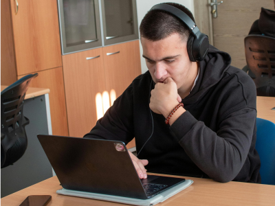 Adult man learning written English through videos to master punctuation, writing rules, and improve the clarity of professional and everyday texts.